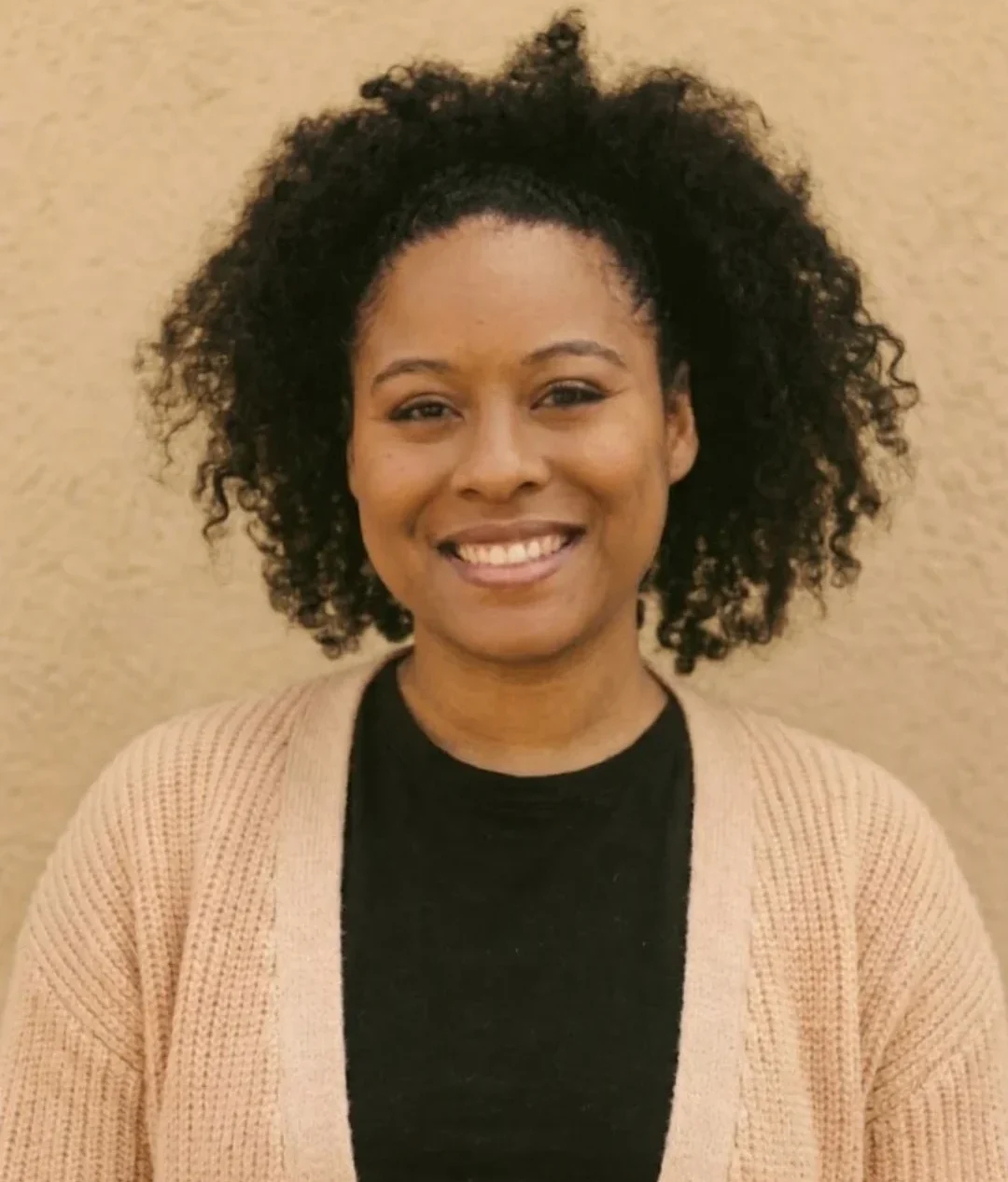 Professional portrait of midwife Ambar with a welcoming expression and calm presence birth center Durham NC