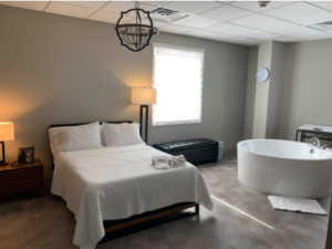 Comfortable birth center room with a bed and birthing tub creating a calm and natural environment birth center Durham NC